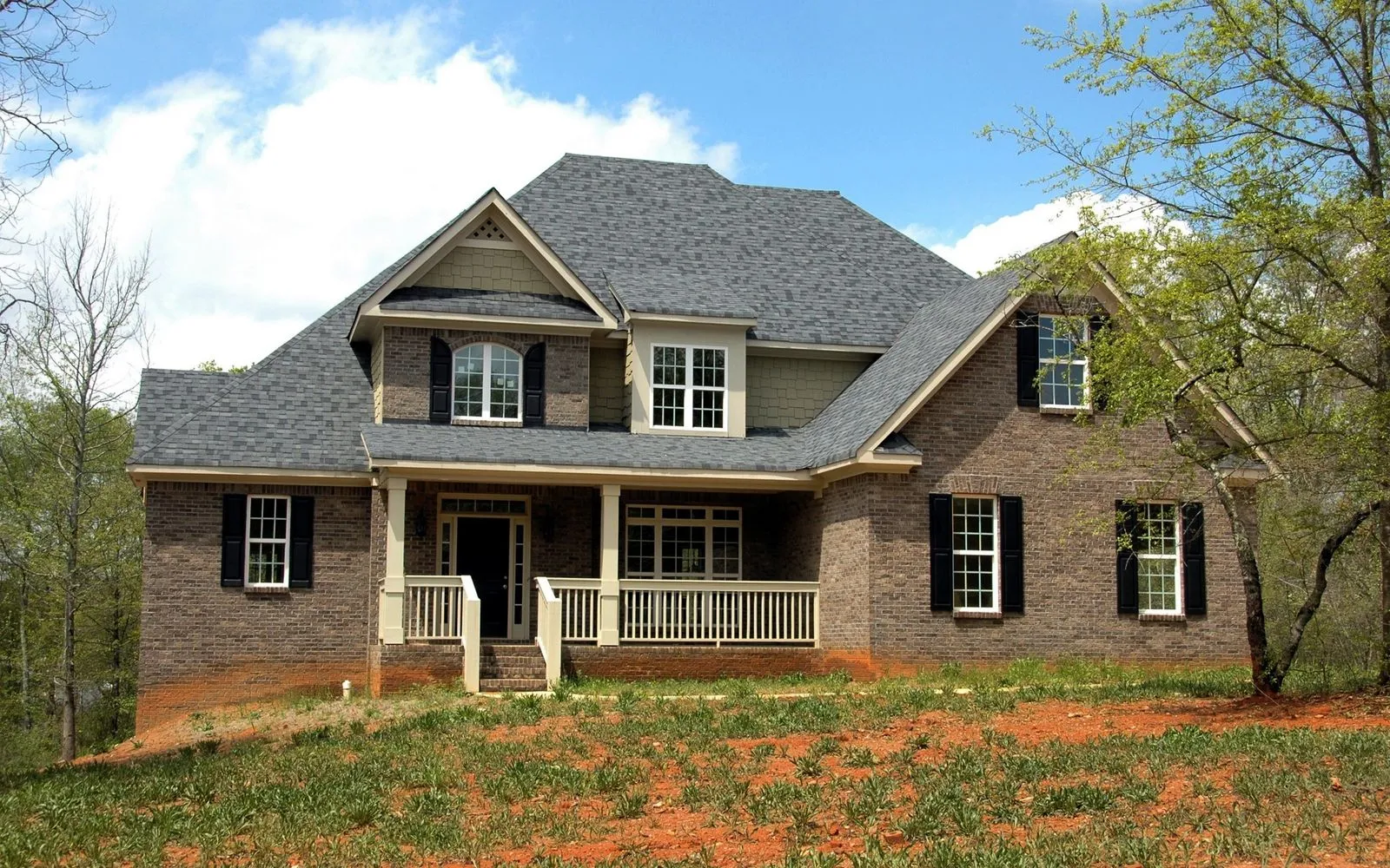 A brick home with a neatly kept front lawn